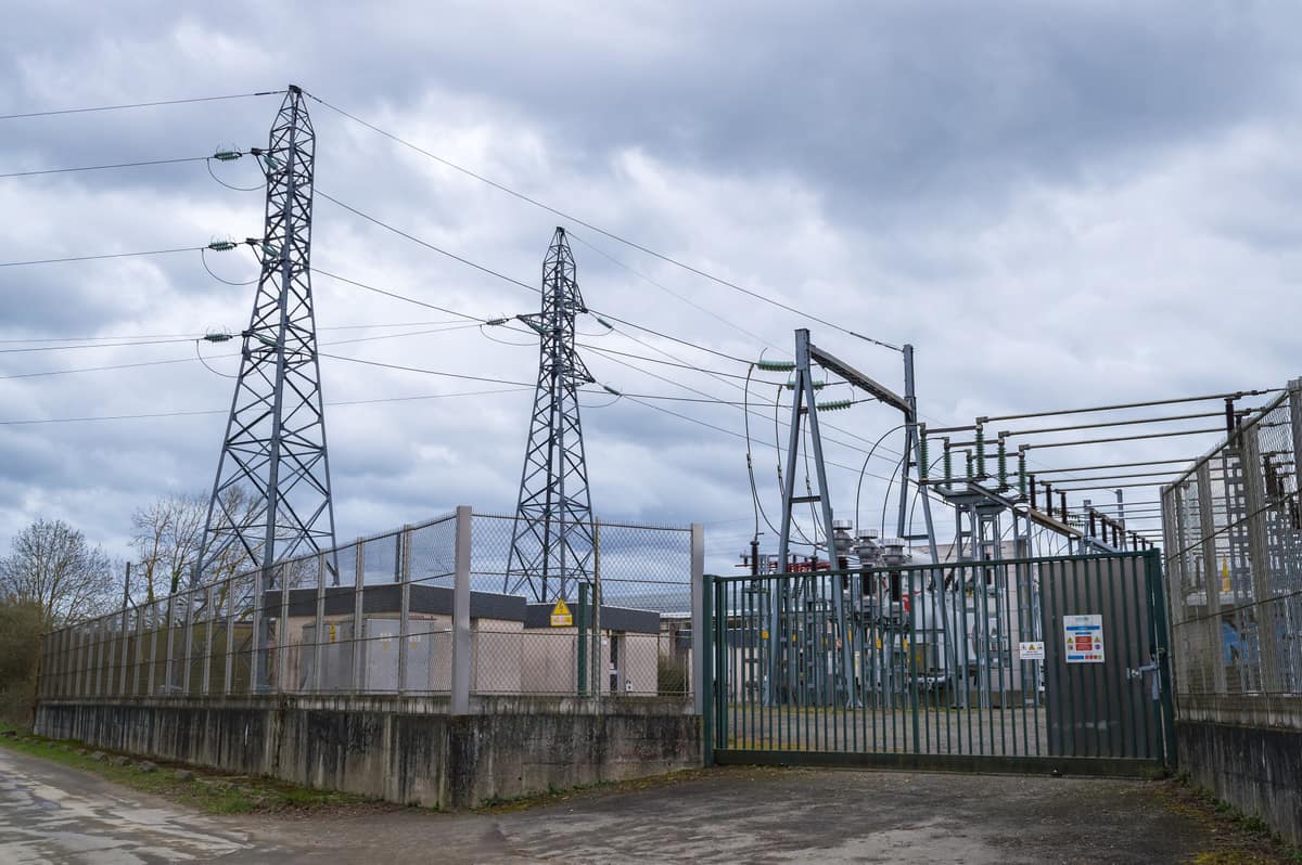 High-voltage substation with pylons, gantries and a fenced compound